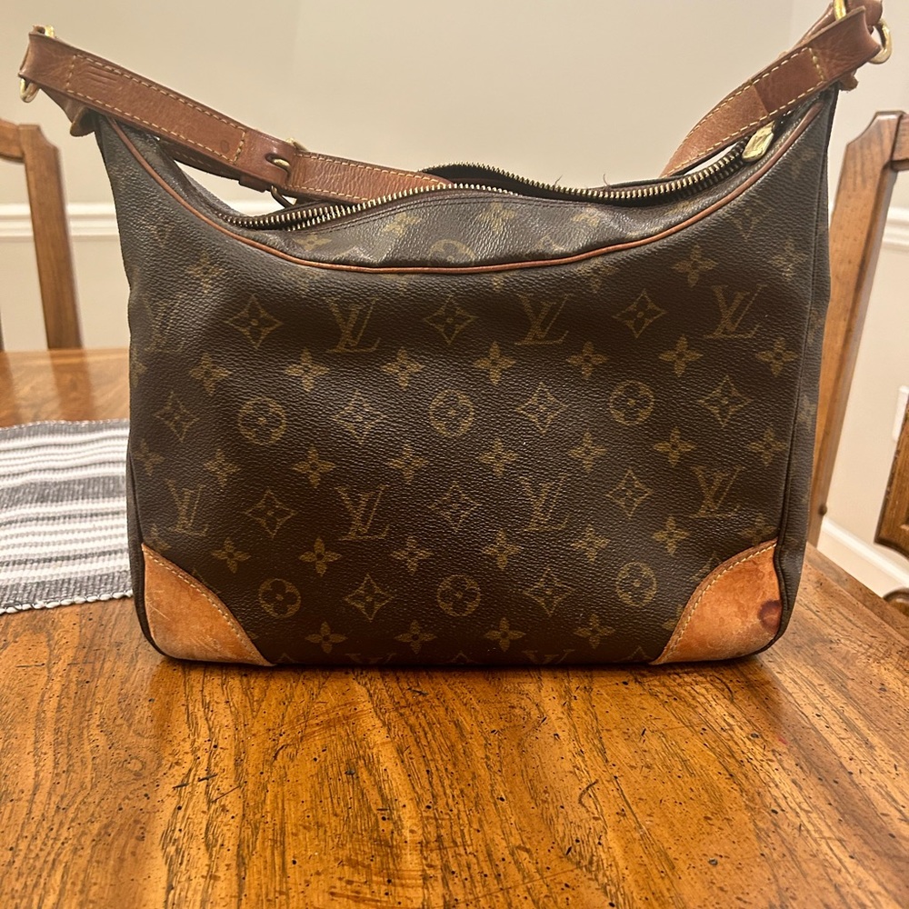 Authentic Louis Vuitton. Been a great purse. Does have darkened patina.